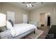 Bright main bedroom featuring neutral colors, a ceiling fan, and access to the en-suite bathroom at 142 Gray Barn Dr, Troutman, NC 28166