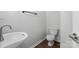 A pristine bathroom featuring modern fixtures, a pedestal sink, and a sleek toilet at 14649 Lions Paw St, Charlotte, NC 28273