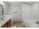 Well-lit bathroom featuring a large tub and sink with wooden cabinets at 14649 Lions Paw St, Charlotte, NC 28273