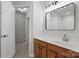 Bright bathroom features a wood vanity, white countertop, and a large, framed mirror at 14649 Lions Paw St, Charlotte, NC 28273