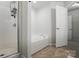 Bright bathroom features a tub, separate shower with a tiled floor, and an open entry at 14649 Lions Paw St, Charlotte, NC 28273