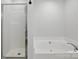 This bathroom features a tub and a separate shower with sleek fixtures and a clean design at 14649 Lions Paw St, Charlotte, NC 28273