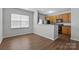Dining room view showcasing hardwood flooring and natural light, highlighting kitchen access at 14649 Lions Paw St, Charlotte, NC 28273