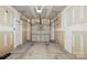 This is an empty garage with a garage door, concrete floor, and side door at 14649 Lions Paw St, Charlotte, NC 28273