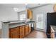 Spacious kitchen view with sink, stainless steel appliances, and wood cabinets, enhancing functionality and style at 14649 Lions Paw St, Charlotte, NC 28273