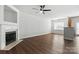 Bright living room with a fireplace, hardwood floors, and large windows offering plenty of natural light at 14649 Lions Paw St, Charlotte, NC 28273