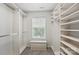 Large, well-organized walk-in closet with custom shelving, drawers, and a window bench at 14649 Lions Paw St, Charlotte, NC 28273