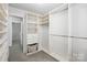 Well-organized walk-in closet with custom shelving, drawers, and a clean, neutral aesthetic at 14649 Lions Paw St, Charlotte, NC 28273