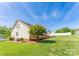A view of the backyard with a wooden deck and beautiful lawn at 1556 Berkshire Dr, Newton, NC 28658