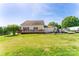 Spacious backyard featuring a wooden deck, a basketball hoop, and ample green space at 1556 Berkshire Dr, Newton, NC 28658