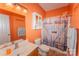This full bathroom features tile floors, a single sink vanity, and a shower-tub combo at 1556 Berkshire Dr, Newton, NC 28658