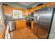 Modern kitchen featuring stainless steel appliances, granite countertops, and light wood cabinets, creating a functional cooking space at 1556 Berkshire Dr, Newton, NC 28658