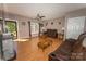 Inviting living room featuring hardwood floors, a ceiling fan, and comfortable brown couches at 1556 Berkshire Dr, Newton, NC 28658