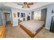 This primary bedroom offers natural light, a ceiling fan, and a convenient walk in closet at 1556 Berkshire Dr, Newton, NC 28658