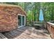 Wooden deck with table and umbrella, perfect for outdoor dining and relaxation, surrounded by lush greenery at 182 Freedom Mill Rd, Gastonia, NC 28052