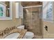 Bathroom featuring granite countertops, tile shower with glass door, and tan walls at 182 Freedom Mill Rd, Gastonia, NC 28052