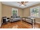 Bedroom featuring hardwood flooring, two windows, a ceiling fan, and a loveseat at 182 Freedom Mill Rd, Gastonia, NC 28052