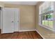 Bedroom with hardwood flooring, neutral walls, closet, and a window overlooking the driveway at 182 Freedom Mill Rd, Gastonia, NC 28052