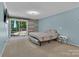 Bedroom with neutral carpet, TV, and sliding doors to an outdoor deck at 182 Freedom Mill Rd, Gastonia, NC 28052
