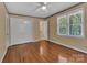 Bedroom featuring hardwood flooring, two large windows and neutral walls, and a ceiling fan at 182 Freedom Mill Rd, Gastonia, NC 28052