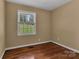 Bedroom with hardwood flooring, neutral walls, and a large window at 182 Freedom Mill Rd, Gastonia, NC 28052