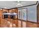 Open kitchen with wood cabinetry, black appliances, tile backsplash and access to back deck at 182 Freedom Mill Rd, Gastonia, NC 28052