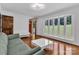 Inviting living room offers large windows, hardwood floors and neutral, modern decor at 182 Freedom Mill Rd, Gastonia, NC 28052