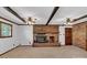 Comfortable living room with a brick fireplace, ceiling beams, and traditional ceiling fans at 182 Freedom Mill Rd, Gastonia, NC 28052