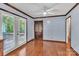 Bright room featuring hardwood floors, ceiling fan, and access to the deck at 182 Freedom Mill Rd, Gastonia, NC 28052