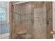 Glass shower featuring tiled walls and a shower seat at 182 Freedom Mill Rd, Gastonia, NC 28052