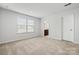 Bedroom with neutral carpet, light walls, a window with blinds, and access to a bathroom at 1933 Tin Roof Ln, Monroe, NC 28112