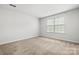 Bedroom with neutral carpet, light walls, and a window with blinds at 1933 Tin Roof Ln, Monroe, NC 28112