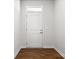Clean entryway with a white door, modern hardware, and wood floors at 1933 Tin Roof Ln, Monroe, NC 28112
