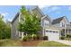 This two-story home has stone accents and a well-manicured lawn at 1933 Tin Roof Ln, Monroe, NC 28112