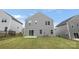 Rear exterior view featuring neutral siding, patio, and grassy lawn at 1933 Tin Roof Ln, Monroe, NC 28112