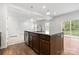 Kitchen island with a sink, granite countertops, and stainless steel appliances at 1933 Tin Roof Ln, Monroe, NC 28112