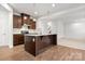 Open kitchen with a large island, wooden cabinets, and stainless steel appliances at 1933 Tin Roof Ln, Monroe, NC 28112
