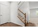 Staircase with carpeted steps, white risers, and wood handrail at 1933 Tin Roof Ln, Monroe, NC 28112
