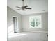A spacious bedroom featuring neutral carpet, a ceiling fan, and natural light from the window at 200 N Kayla Dr, Salisbury, NC 28146