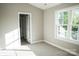 A sunlit bedroom with plush carpet, fresh paint, and a window offering a view of the outdoors at 200 N Kayla Dr, Salisbury, NC 28146