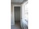 A well-organized closet is shown with neutral carpet and wire shelving, bathed in light from the nearby window at 200 N Kayla Dr, Salisbury, NC 28146