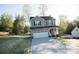 Two-story home with a gray exterior, black shutters, and an attached two-car garage, surrounded by trees at 200 N Kayla Dr, Salisbury, NC 28146