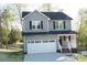 Charming two-story home featuring gray siding, a white garage door, and a covered front porch at 200 N Kayla Dr, Salisbury, NC 28146