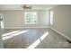 Spacious living room filled with natural light, featuring wood floors, neutral walls, and large windows at 200 N Kayla Dr, Salisbury, NC 28146
