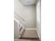A carpeted staircase with a white handrail and natural light from a nearby window at 200 N Kayla Dr, Salisbury, NC 28146