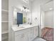 Bathroom features double vanity sinks with white cabinets, a large mirror, and recessed lights above at 217 S Green St, Wadesboro, NC 28170