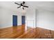 Bedroom features hardwood floors, a ceiling fan, white walls, and a decorative fireplace at 217 S Green St, Wadesboro, NC 28170