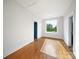 Bedroom features hardwood floors, white walls, blue door, and a large window at 217 S Green St, Wadesboro, NC 28170