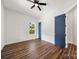 Bedroom featuring hardwood floors, a blue door, and a large window with lots of natural light at 217 S Green St, Wadesboro, NC 28170