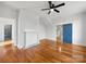 Bedroom boasts hardwood floors, white walls, ceiling fan, decorative fireplace, and blue closet door at 217 S Green St, Wadesboro, NC 28170